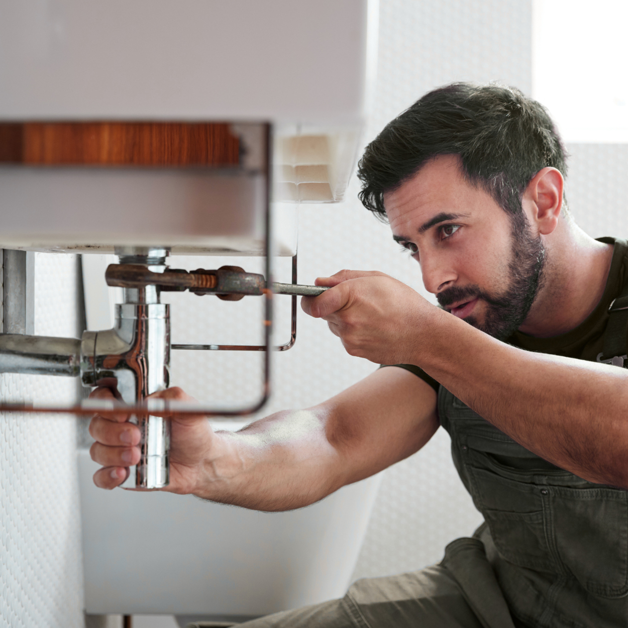 A plumber fixing a sink